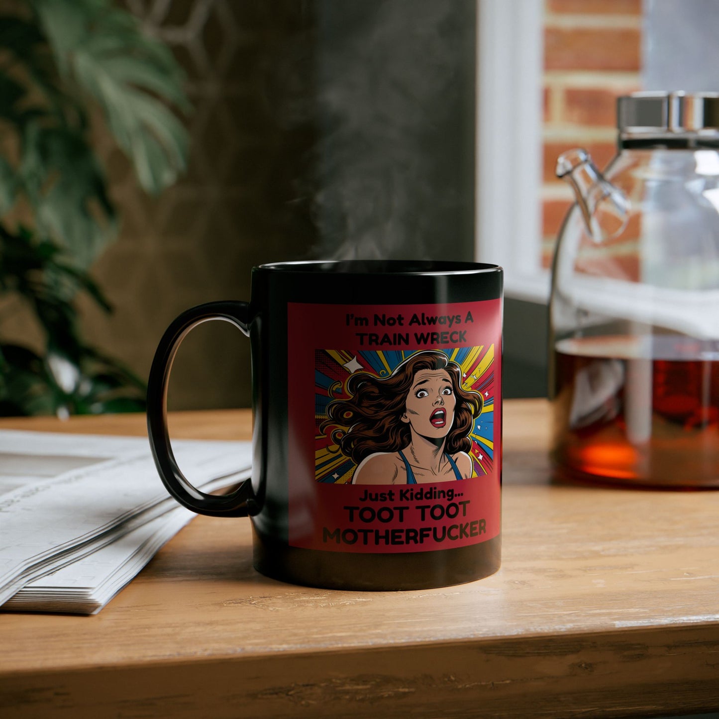 Black mug with a colorful graphic and text on a wooden surface
