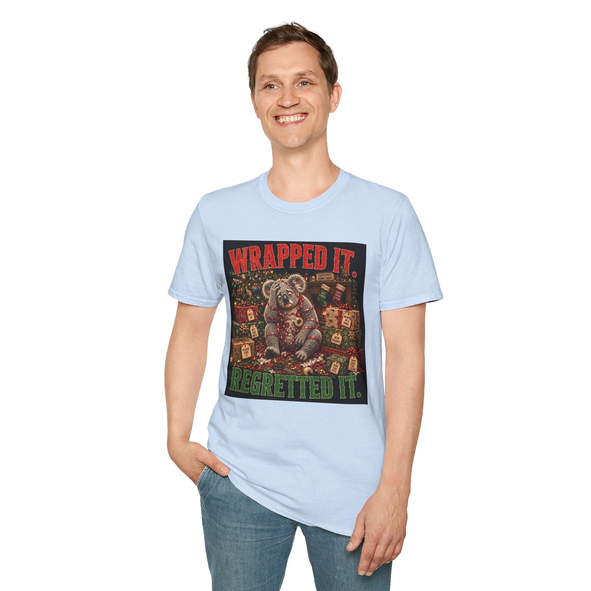 Model wearing the Wrapped It. Regretted It. Koala Christmas T-Shirt in light blue with funny festive koala artwork.