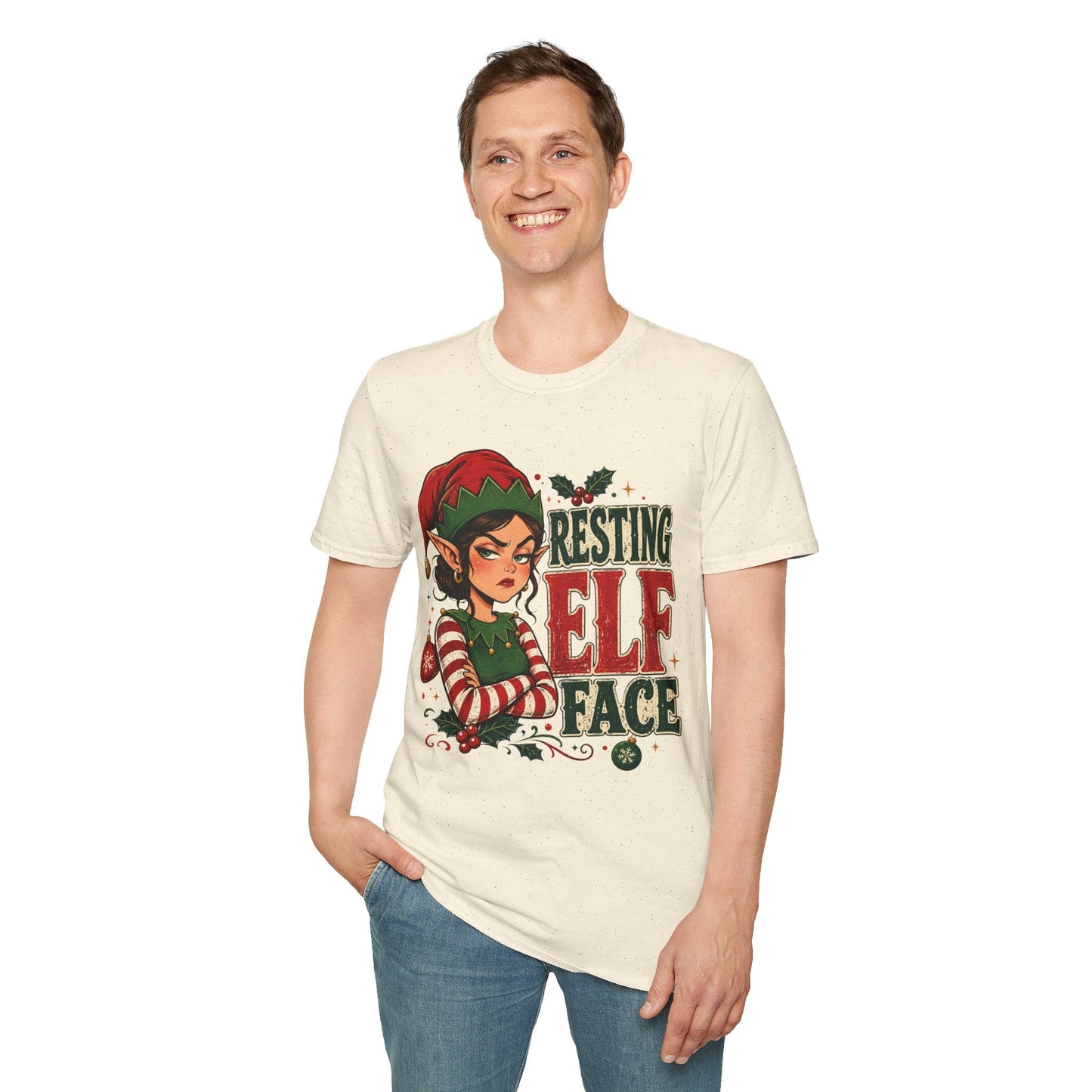 Model wearing the Resting Elf Face Sassy Elf Christmas T-Shirt in natural with funny Christmas elf artwork.