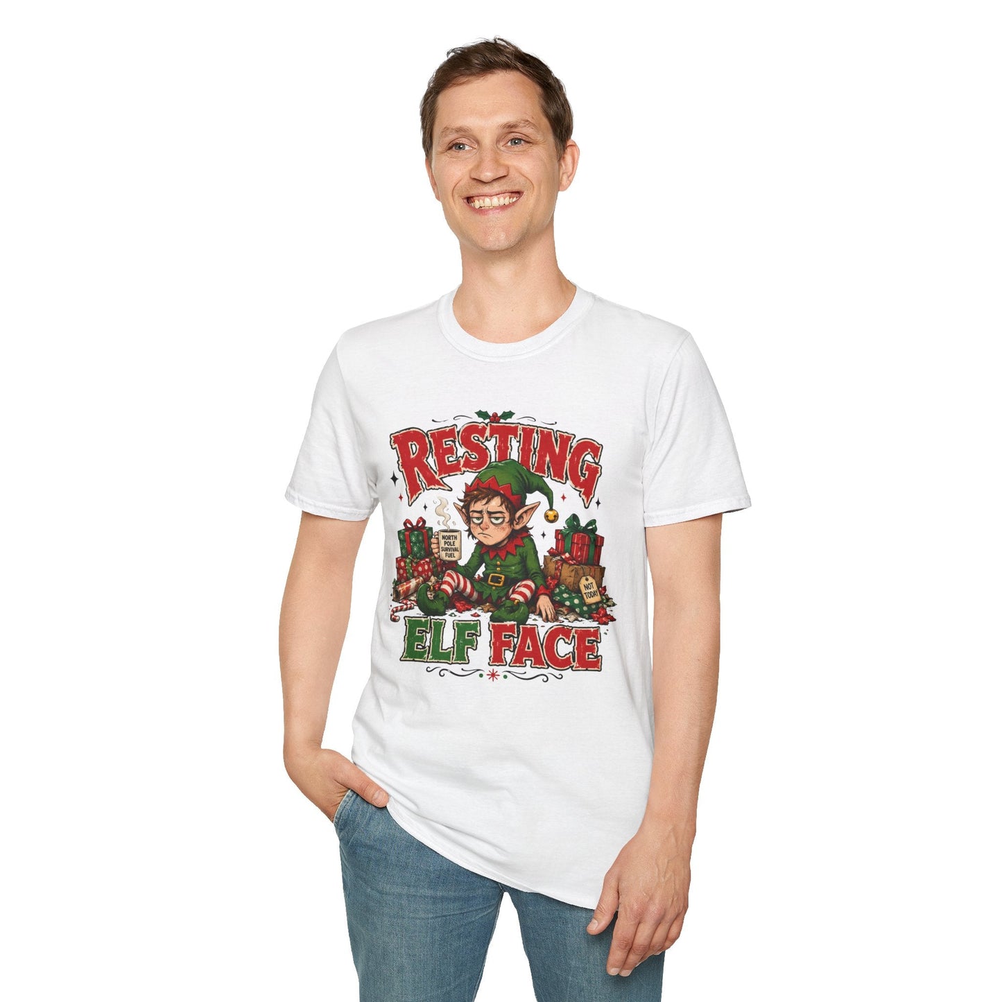 Model wearing the Resting Elf Face Christmas T-Shirt in white with funny tired elf artwork.