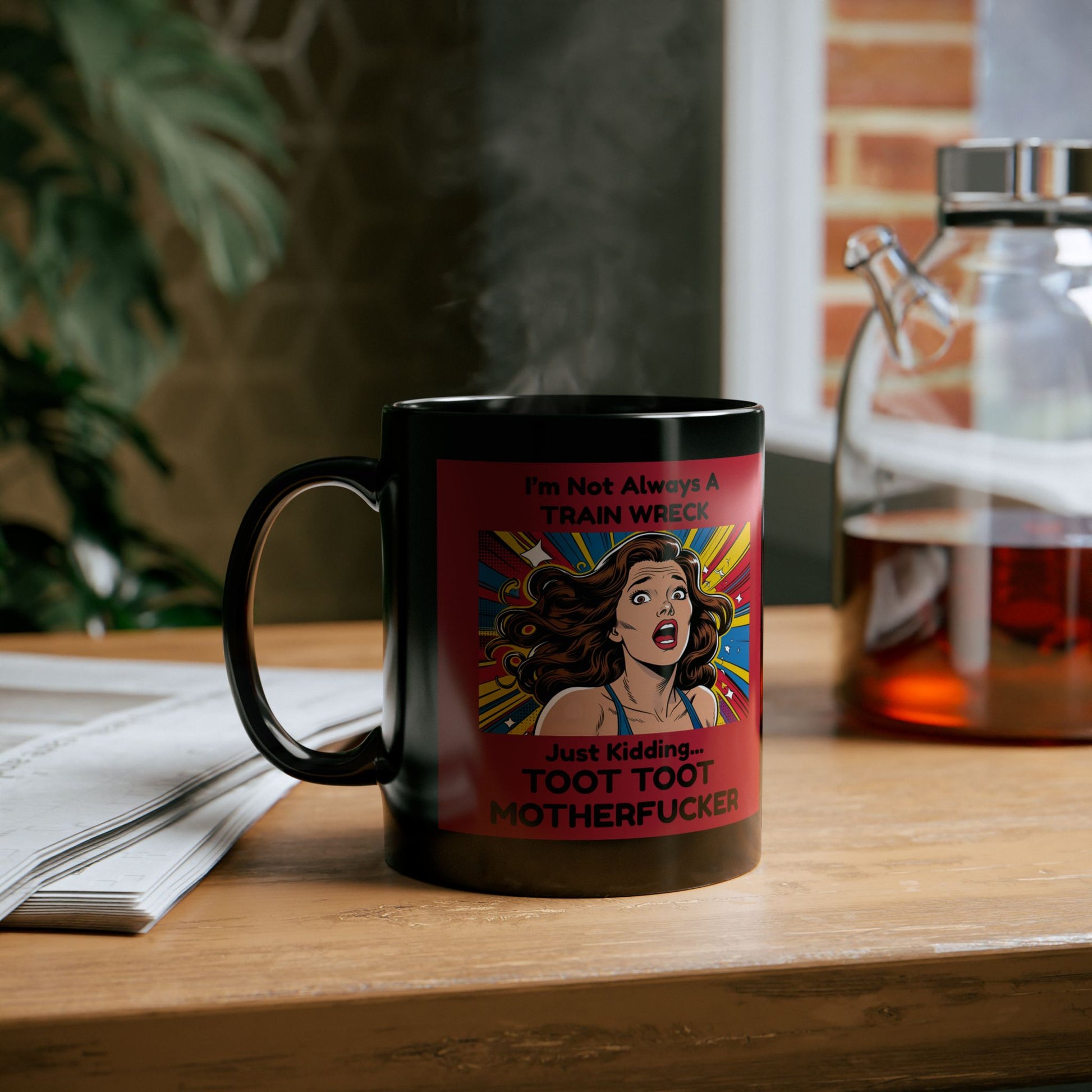 Black mug with a colorful graphic and text on a wooden surface