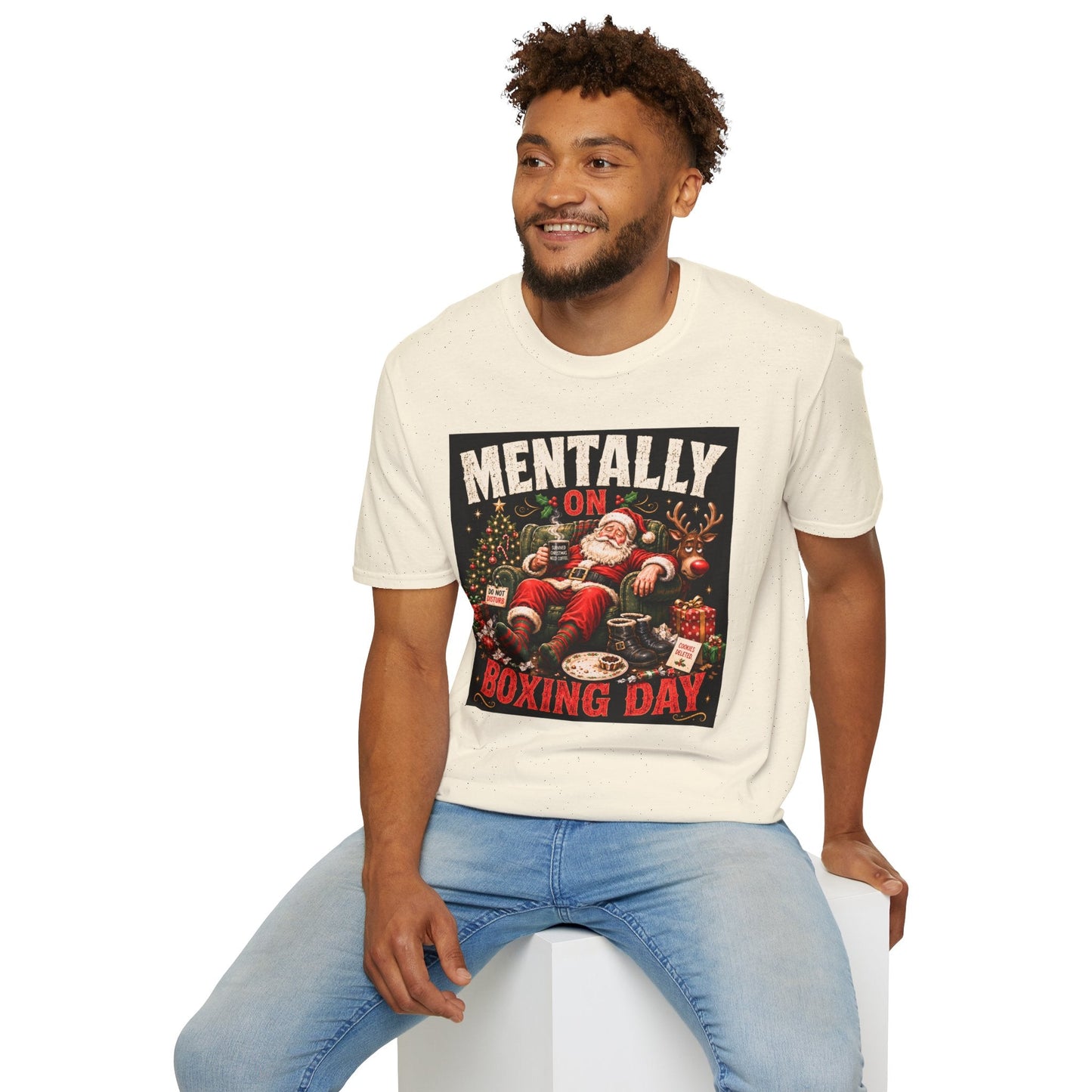 Model wearing the Mentally on Boxing Day Santa Christmas T-Shirt in natural with funny exhausted Santa artwork.