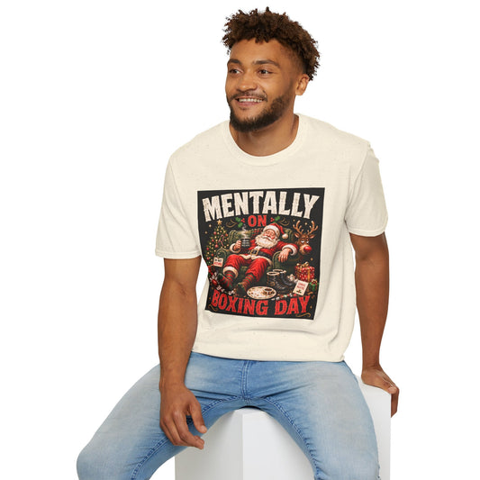 Model wearing the Mentally on Boxing Day Santa Christmas T-Shirt in natural with funny exhausted Santa artwork.