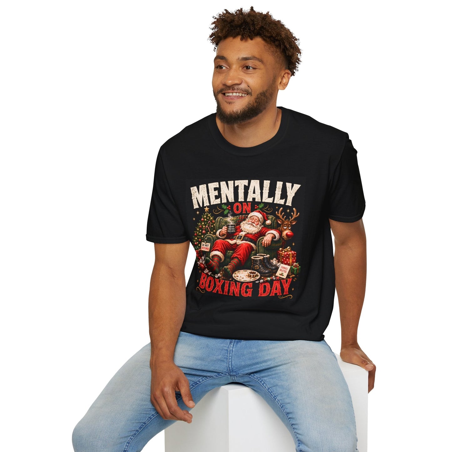 Model wearing the Mentally on Boxing Day Santa Christmas T-Shirt in black, with funny exhausted Santa artwork.