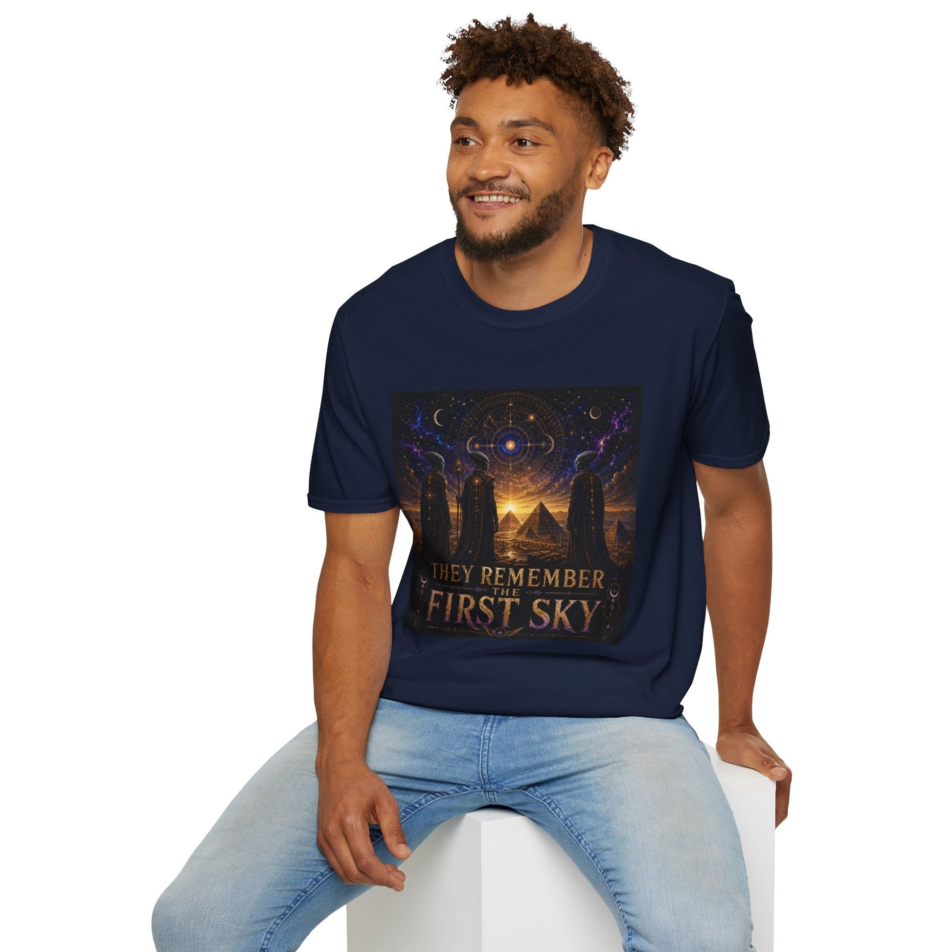 Model wearing the They Remember the First Sky T-Shirt in navy featuring robed alien watchers, pyramids, and a glowing celestial sky map design.