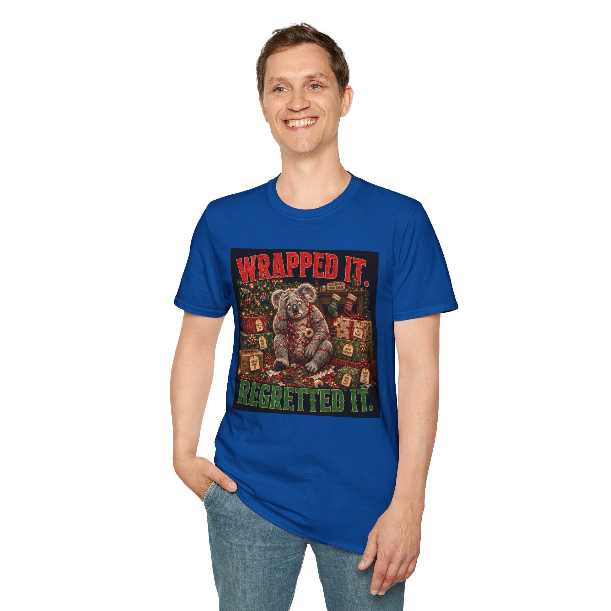 Model wearing the Wrapped It. Regretted It. Koala Christmas T-Shirt in royal, with funny festive koala artwork.