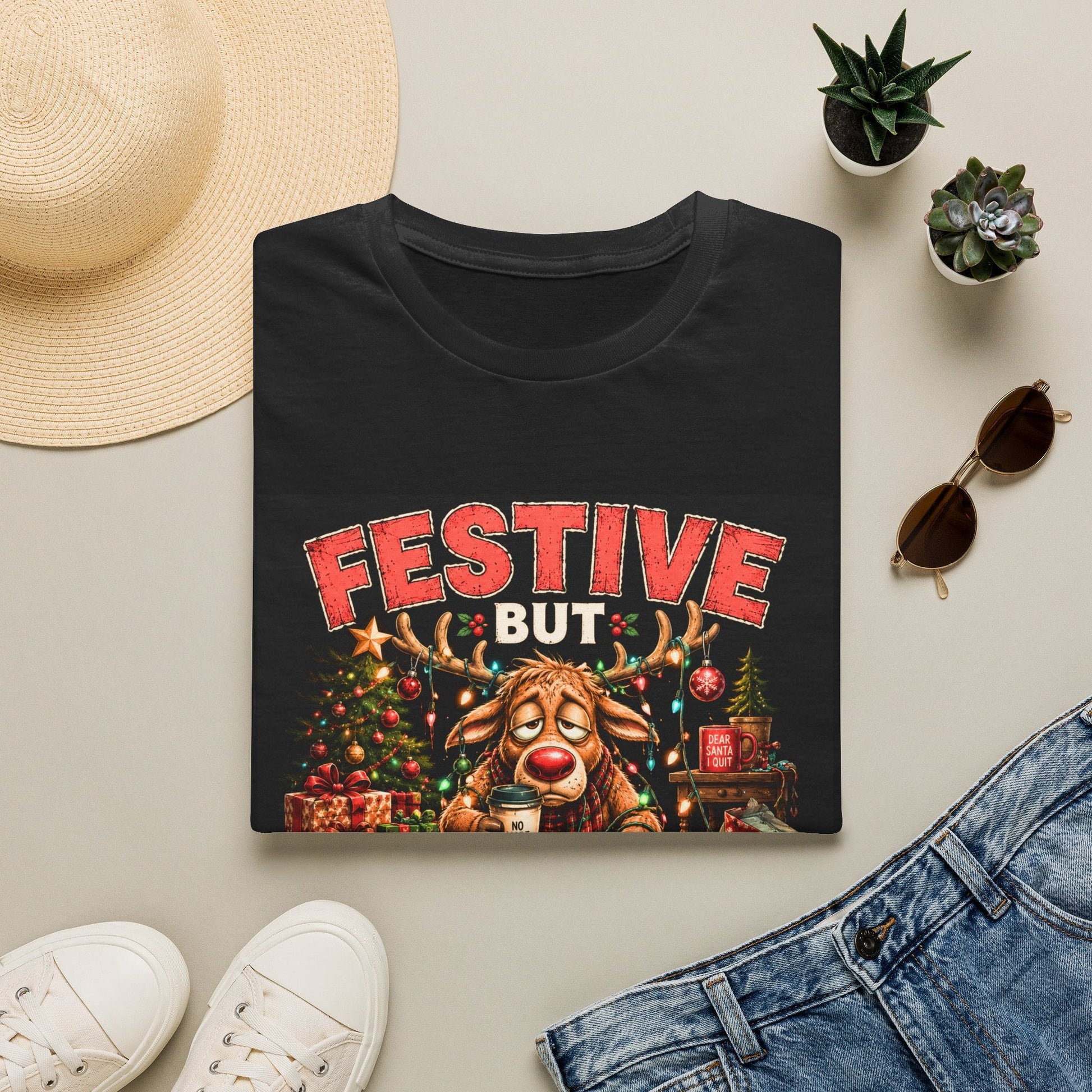 Folded Festive But Tired Reindeer Christmas T-Shirt in black showing funny Christmas reindeer design.