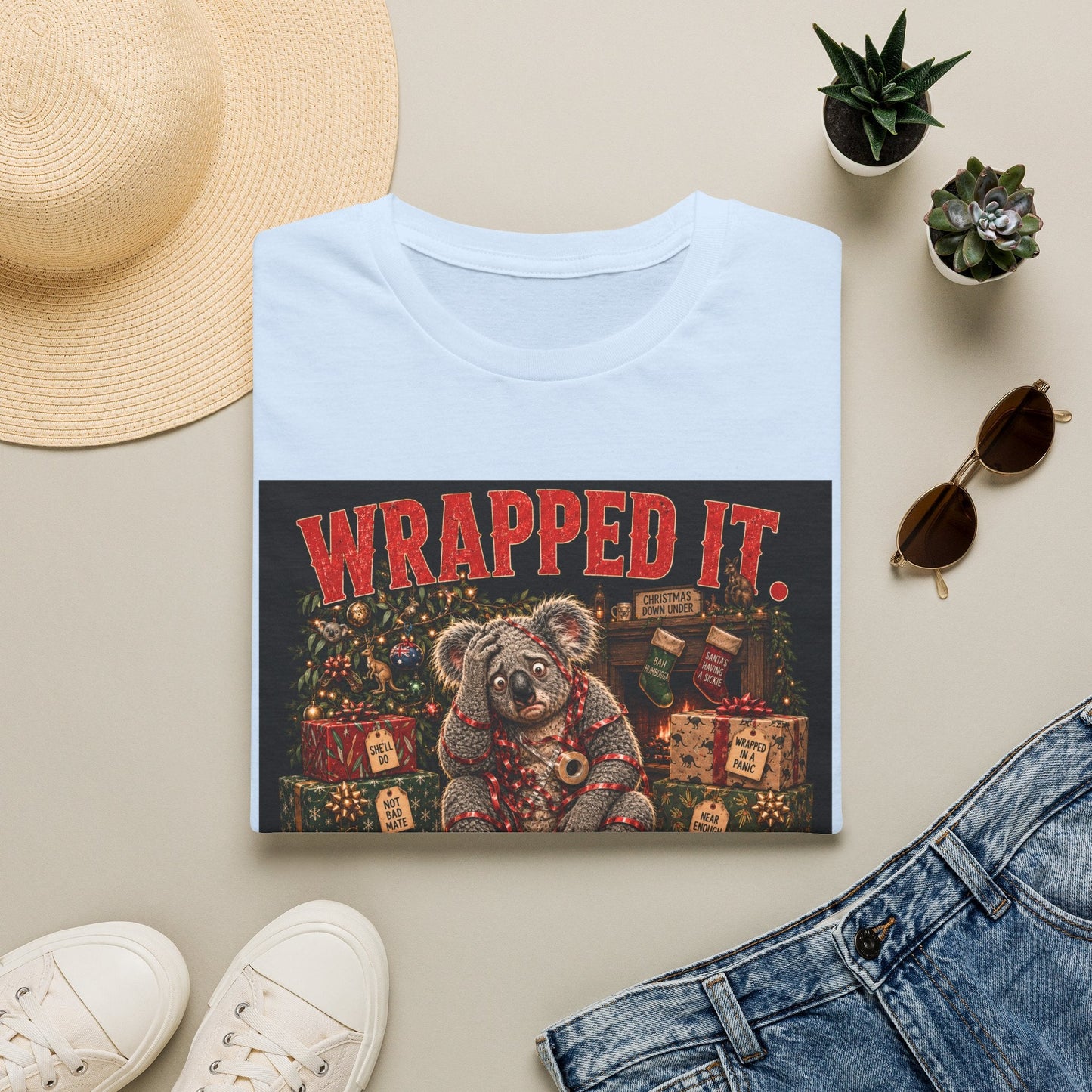 Folded Wrapped It. Regretted It. Koala Christmas T-Shirt in light blue, showing funny Australian Christmas artwork.