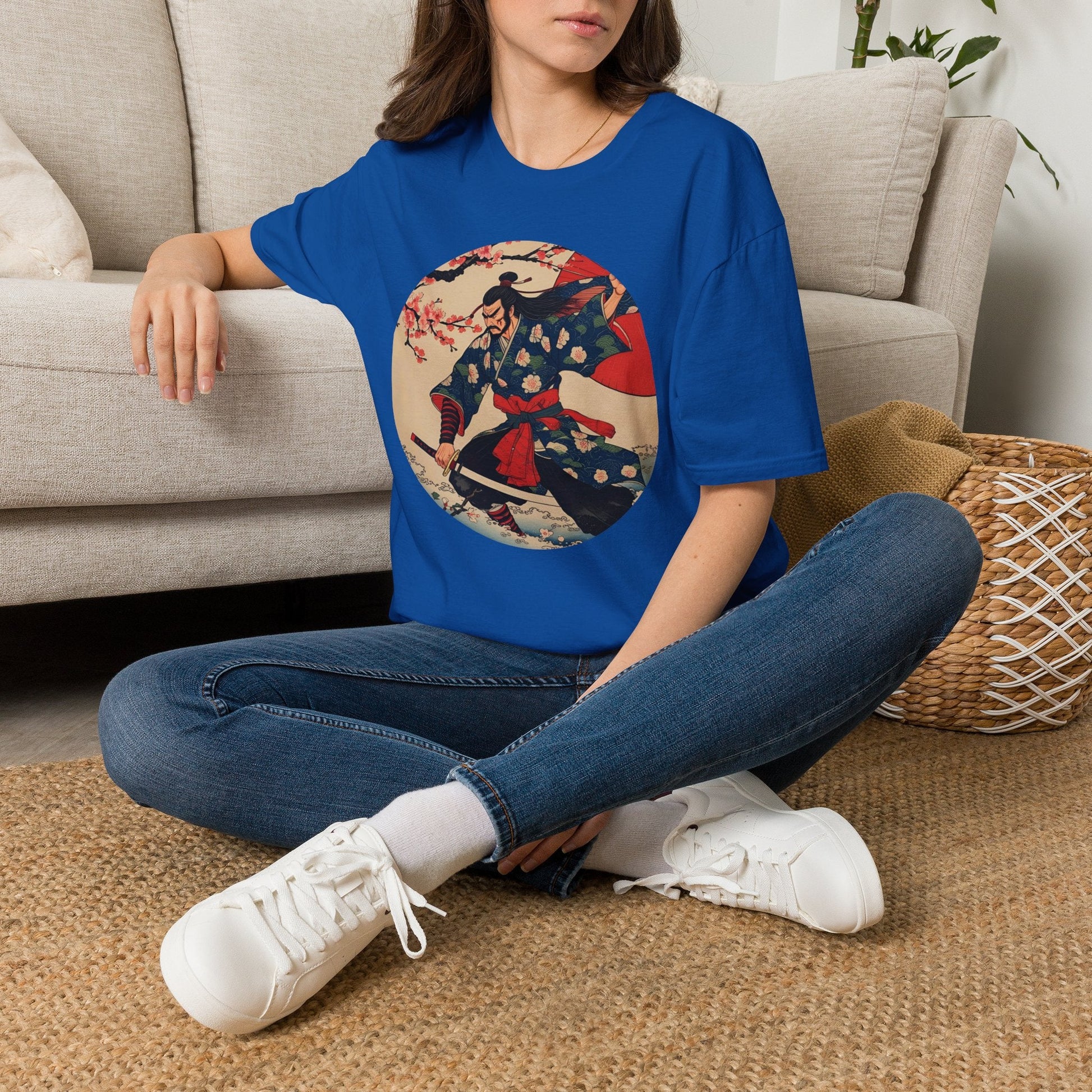 Model wearing the Crimson Bloom Ronin Samurai Warrior T-Shirt in royal featuring a Japanese-inspired samurai in motion with cherry blossoms and crimson accents.