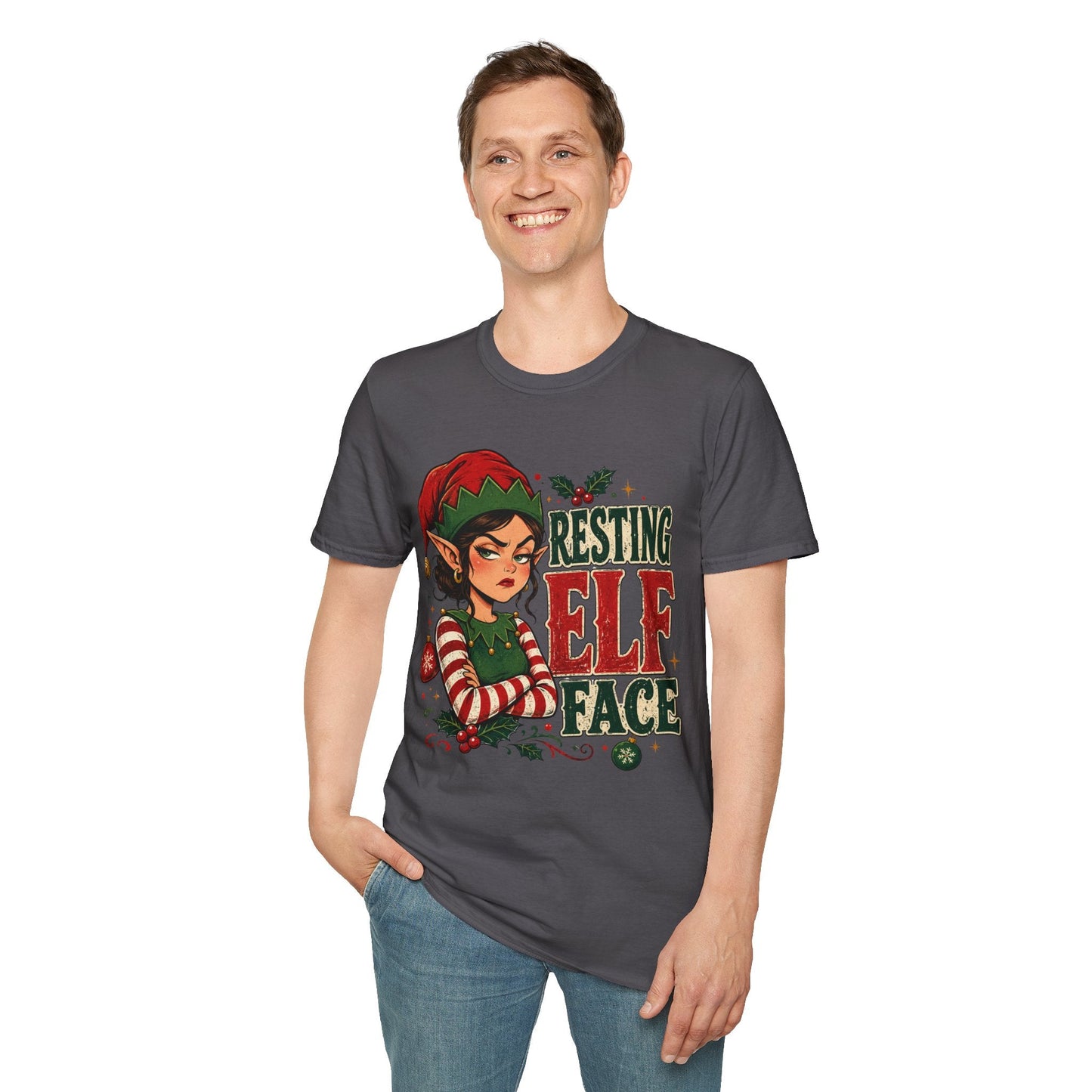 Model wearing the Resting Elf Face Sassy Elf Christmas T-Shirt in charcoal with funny Christmas elf artwork.