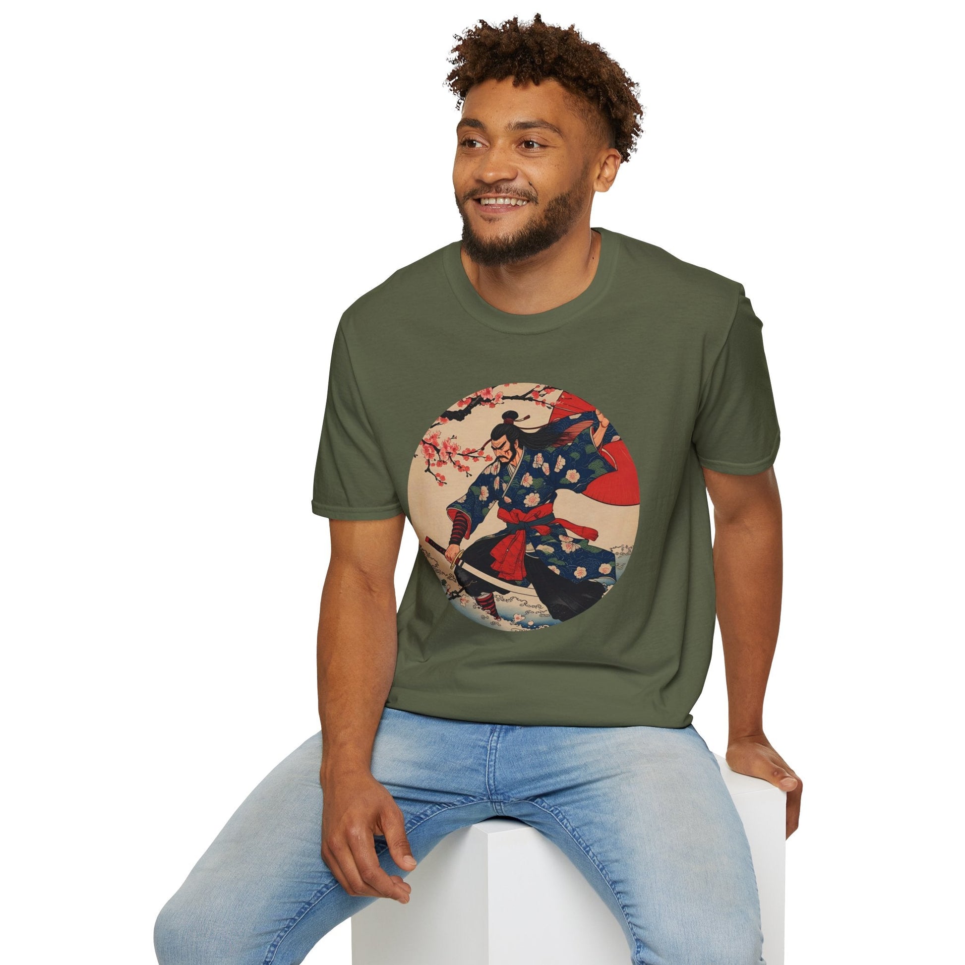 Model wearing the Crimson Bloom Ronin Samurai Warrior T-Shirt in military green featuring a Japanese-inspired samurai in motion with cherry blossoms and crimson accents.