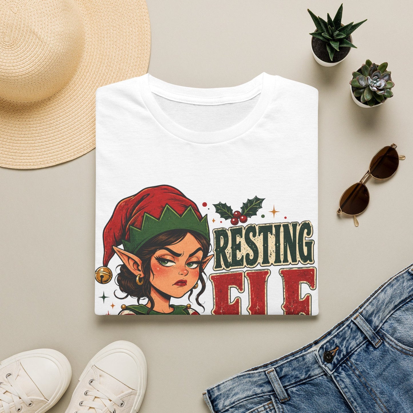Folded Resting Elf Face Sassy Elf Christmas T-Shirt in white showing bold festive elf design.