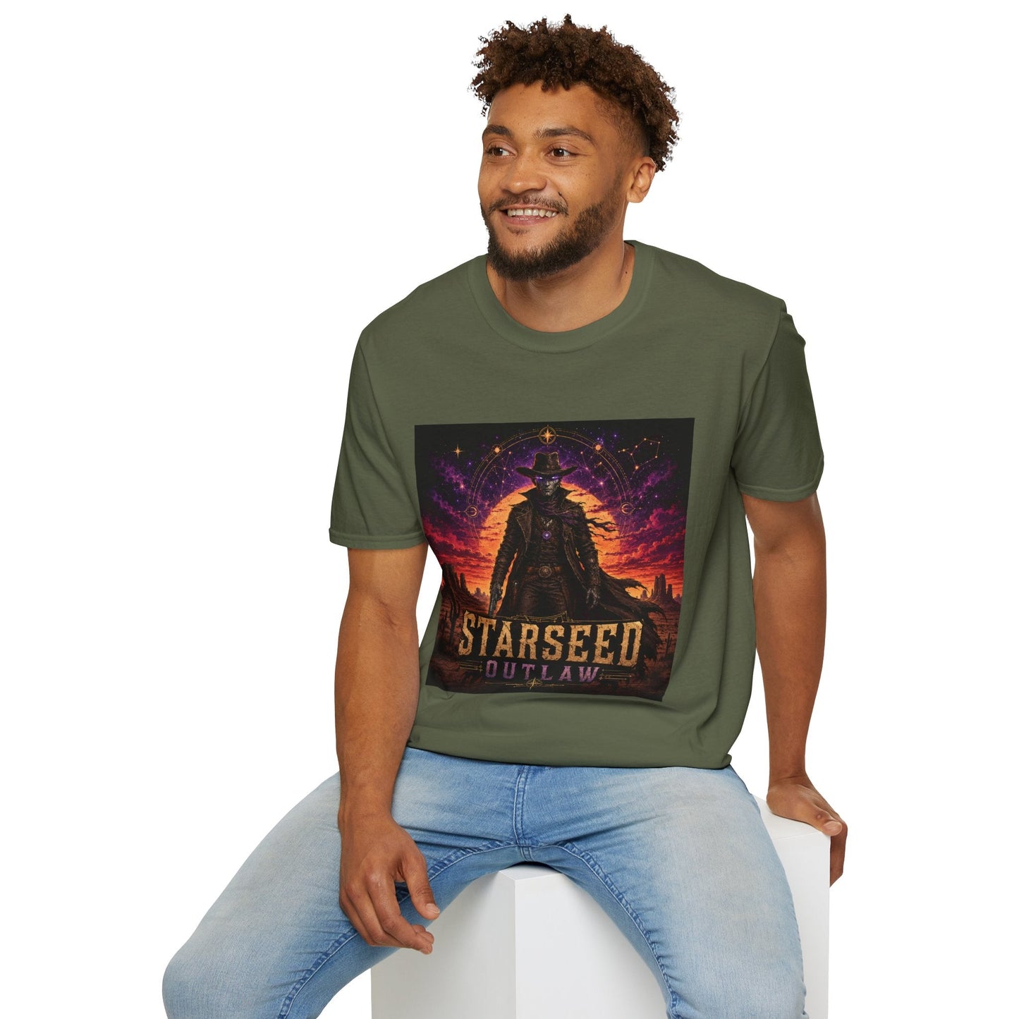 Model wearing Starseed Outlaw graphic T-shirt in military green with sci-fi alien outlaw design.