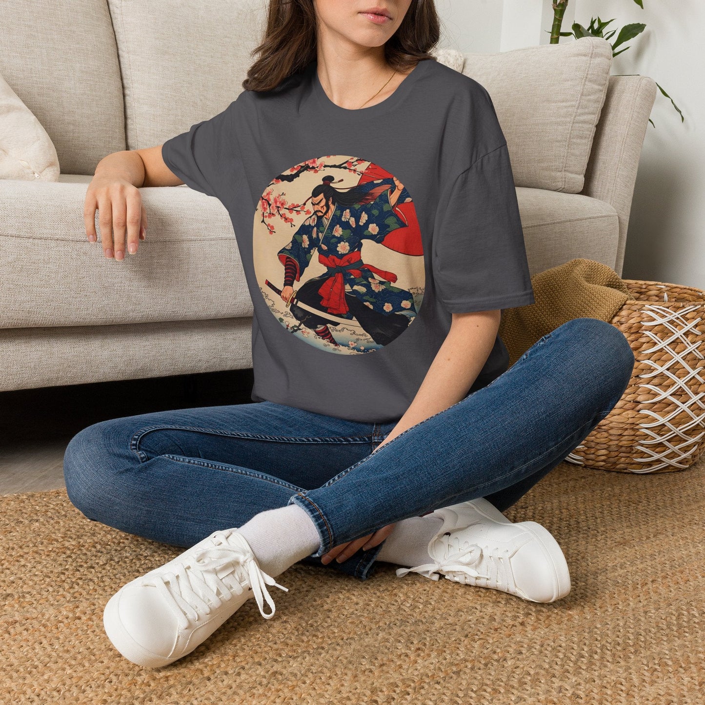 Model wearing the Crimson Bloom Ronin Samurai Warrior T-Shirt in charcoal featuring a Japanese-inspired samurai in motion with cherry blossoms and crimson accents.
