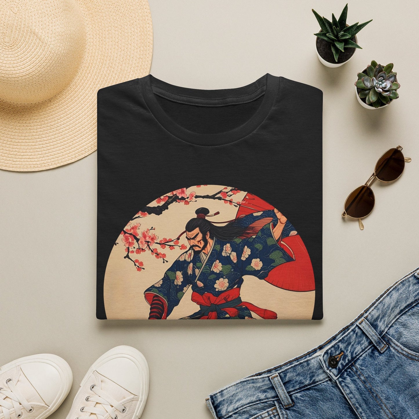 Folded Crimson Bloom Ronin Samurai Warrior T-Shirt in black showing vintage-style samurai artwork with cherry blossoms, red parasol and dynamic warrior pose.
