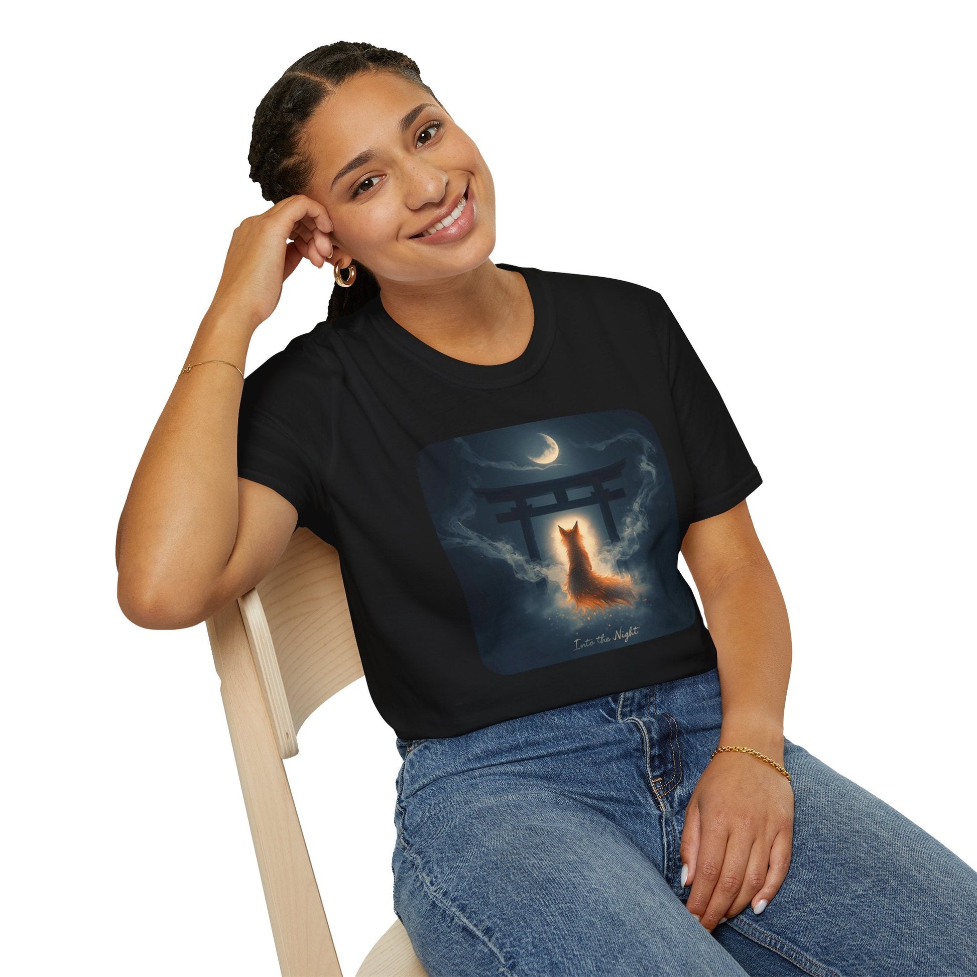 Model wearing the Into the Night Mystic Fox at the Torii T-Shirt in black  featuring a glowing fox spirit beneath a torii gate and crescent moon.