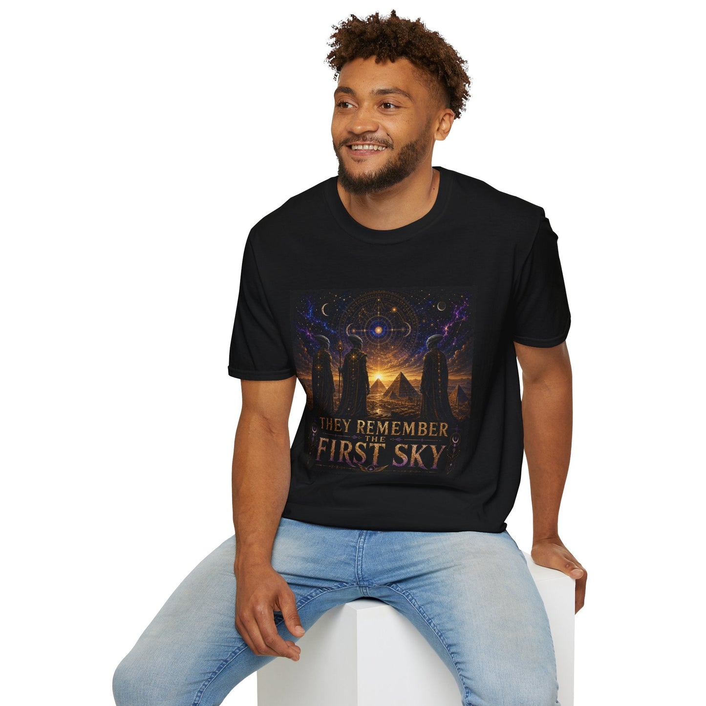 Model wearing the They Remember the First Sky T-Shirt in black featuring robed alien watchers, pyramids, and a glowing celestial sky map design.