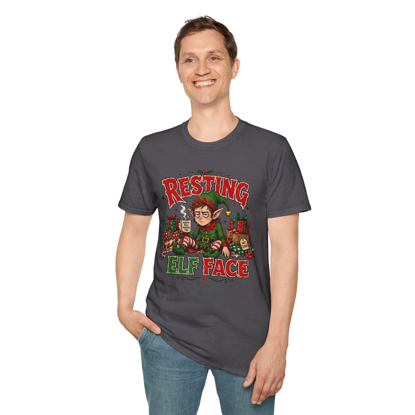 Model wearing the Resting Elf Face Christmas T-Shirt in charcoal with funny tired elf artwork.