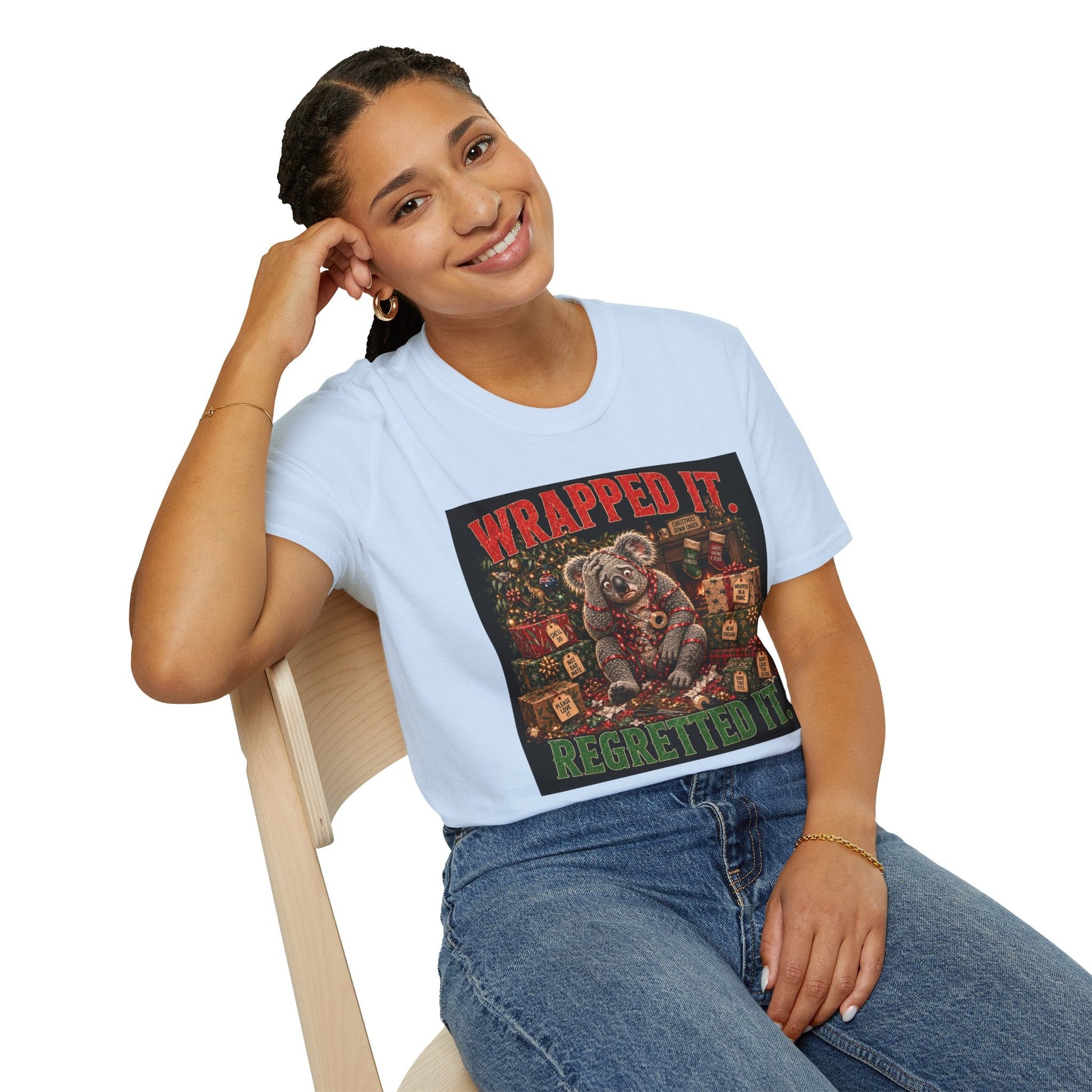 Model wearing the Wrapped It. Regretted It. Koala Christmas T-Shirt in light blue with funny festive koala artwork.