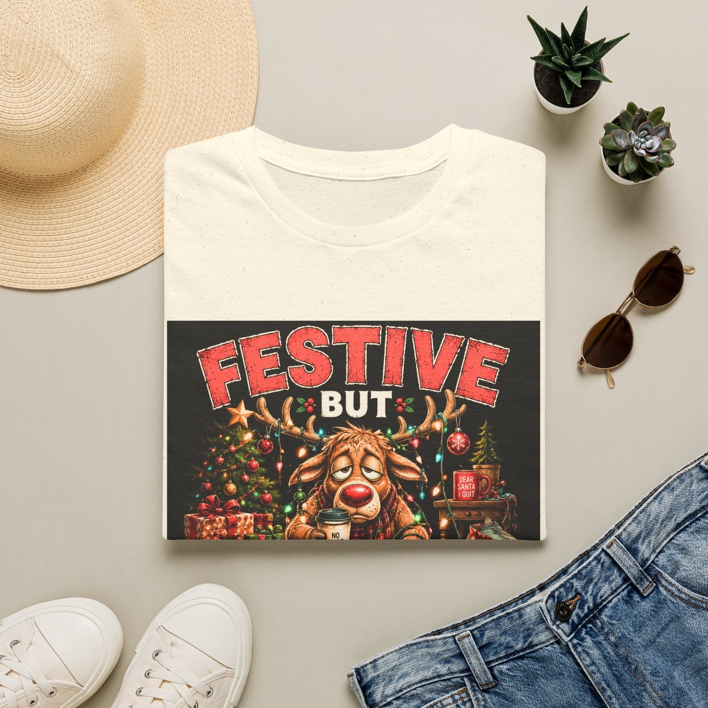 Folded Festive But Tired Reindeer Christmas T-Shirt in natural showing funny Christmas reindeer design.