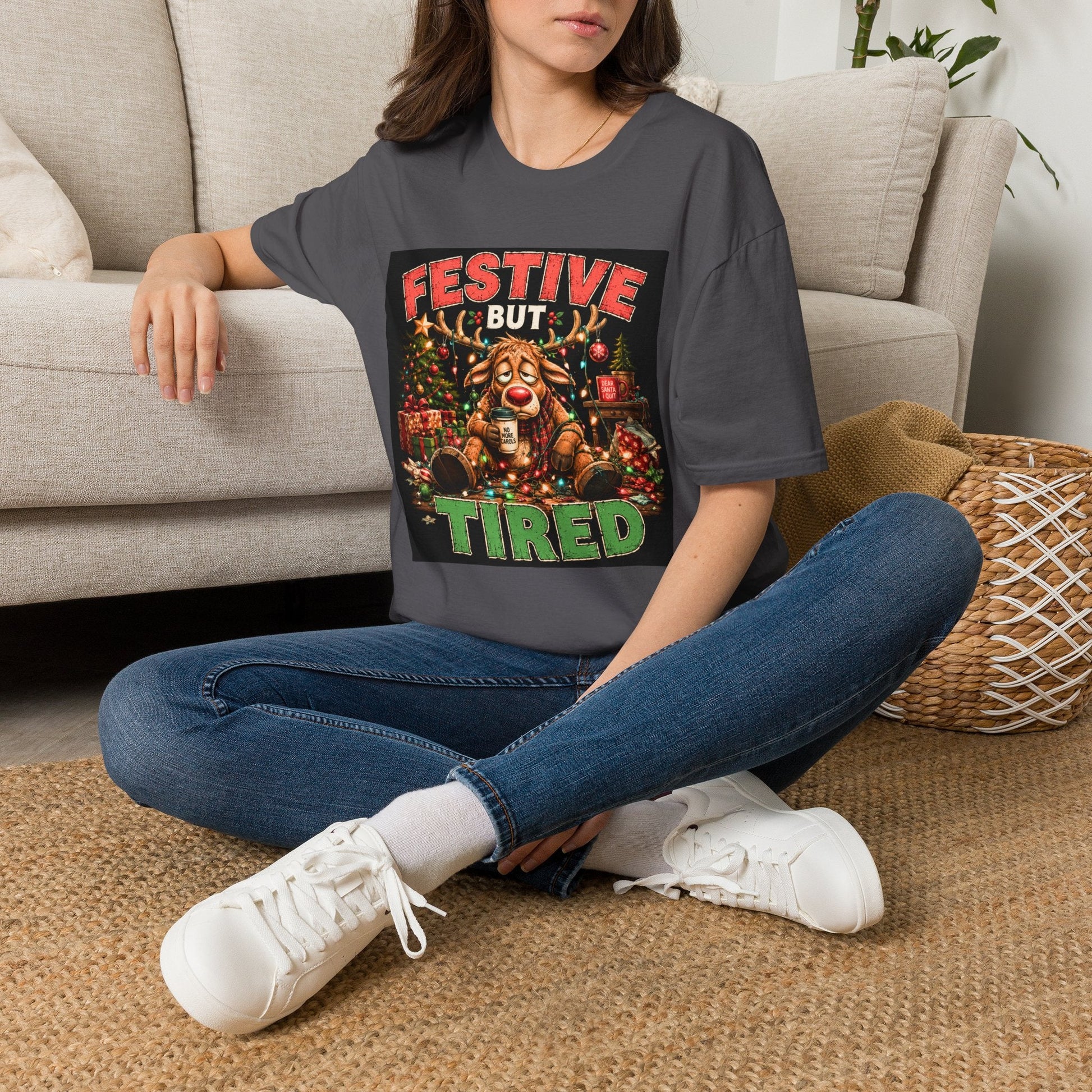 Model wearing the Festive But Tired Reindeer Christmas T-Shirt in charcoal with funny tired reindeer artwork.