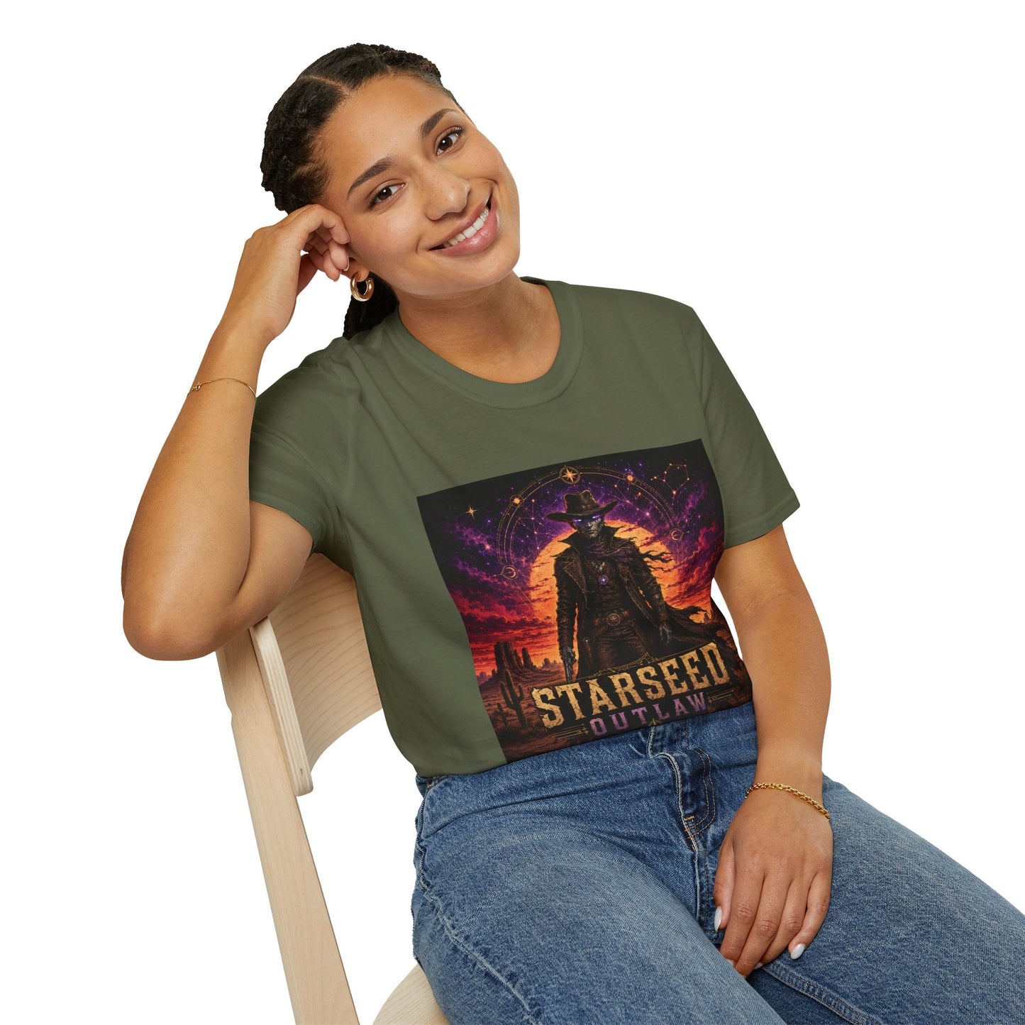 Model wearing Starseed Outlaw graphic T-shirt in military green with sci-fi alien outlaw design.