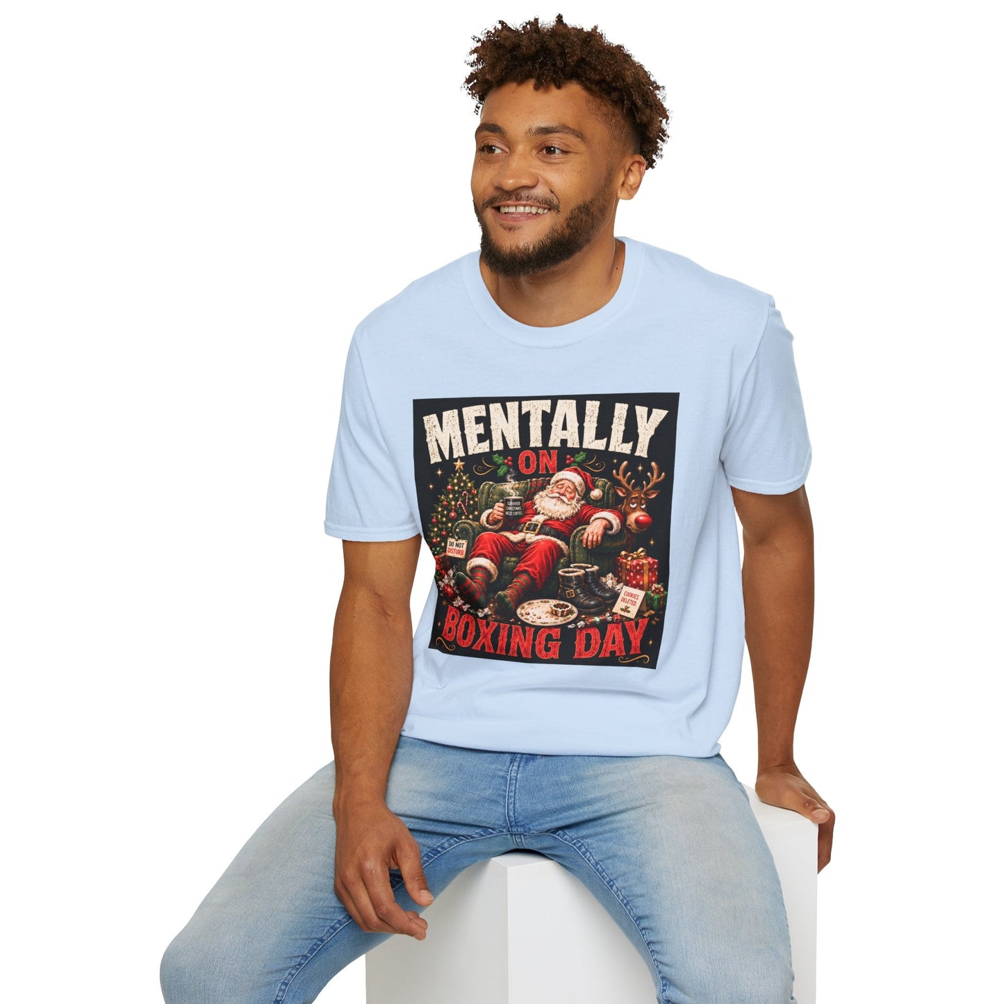 Model wearing the Mentally on Boxing Day Santa Christmas T-Shirt in light blue,  with funny exhausted Santa artwork.