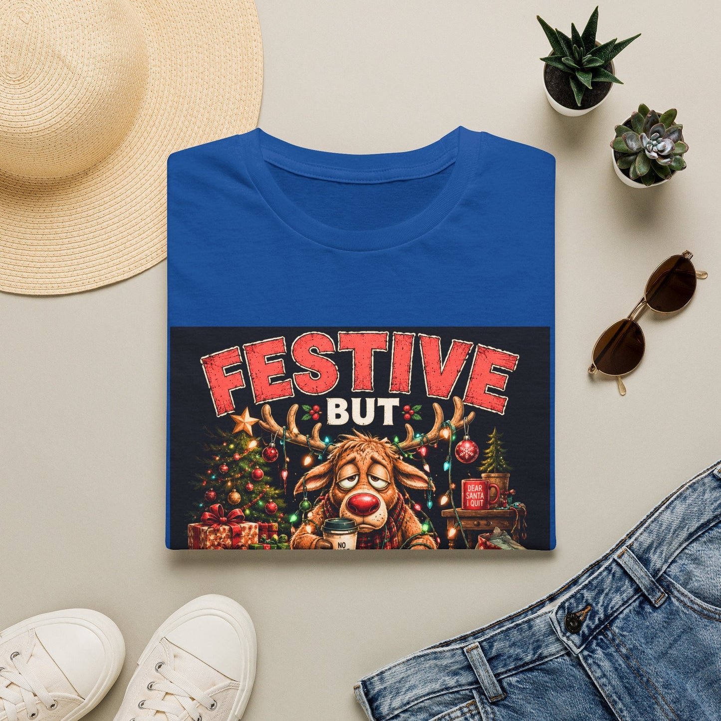 Folded Festive But Tired Reindeer Christmas T-Shirt in royal showing funny Christmas reindeer design.