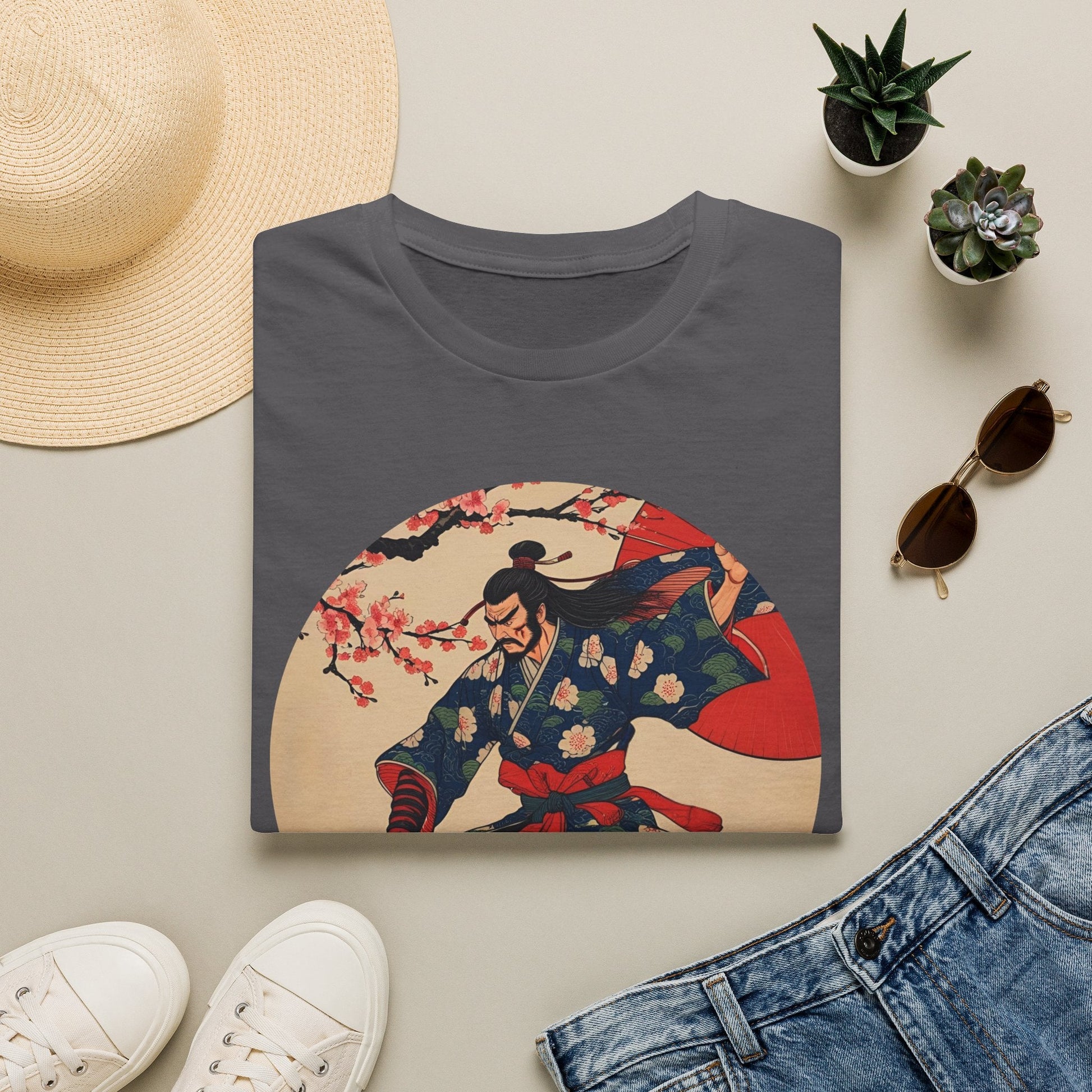 Folded Crimson Bloom Ronin Samurai Warrior T-Shirt in charcoal showing vintage-style samurai artwork with cherry blossoms, red parasol and dynamic warrior pose.