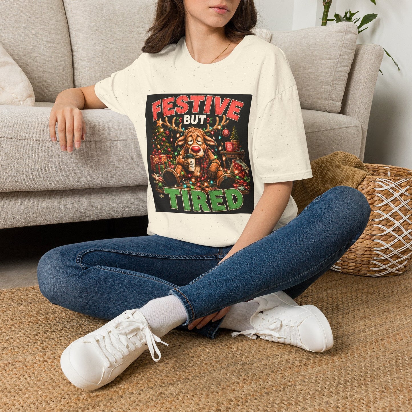 Model wearing the Festive But Tired Reindeer Christmas T-Shirt in natural with funny tired reindeer artwork.