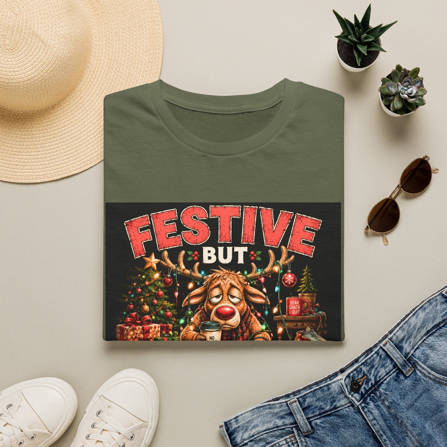 Folded Festive But Tired Reindeer Christmas T-Shirt in military green showing funny Christmas reindeer design.