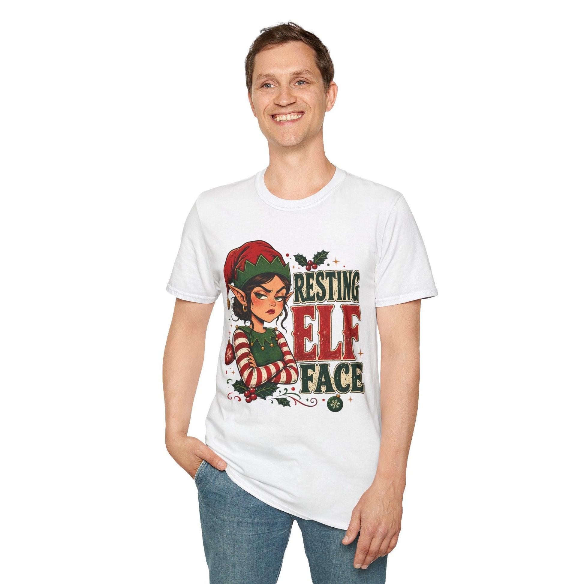 Model wearing the Resting Elf Face Sassy Elf Christmas T-Shirt in white with funny Christmas elf artwork.