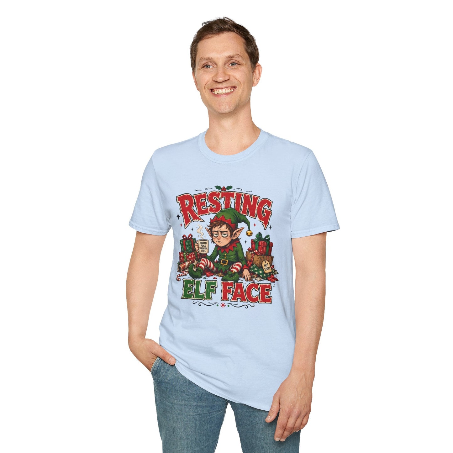 Model wearing the Resting Elf Face Christmas T-Shirt in light blue with funny tired elf artwork.